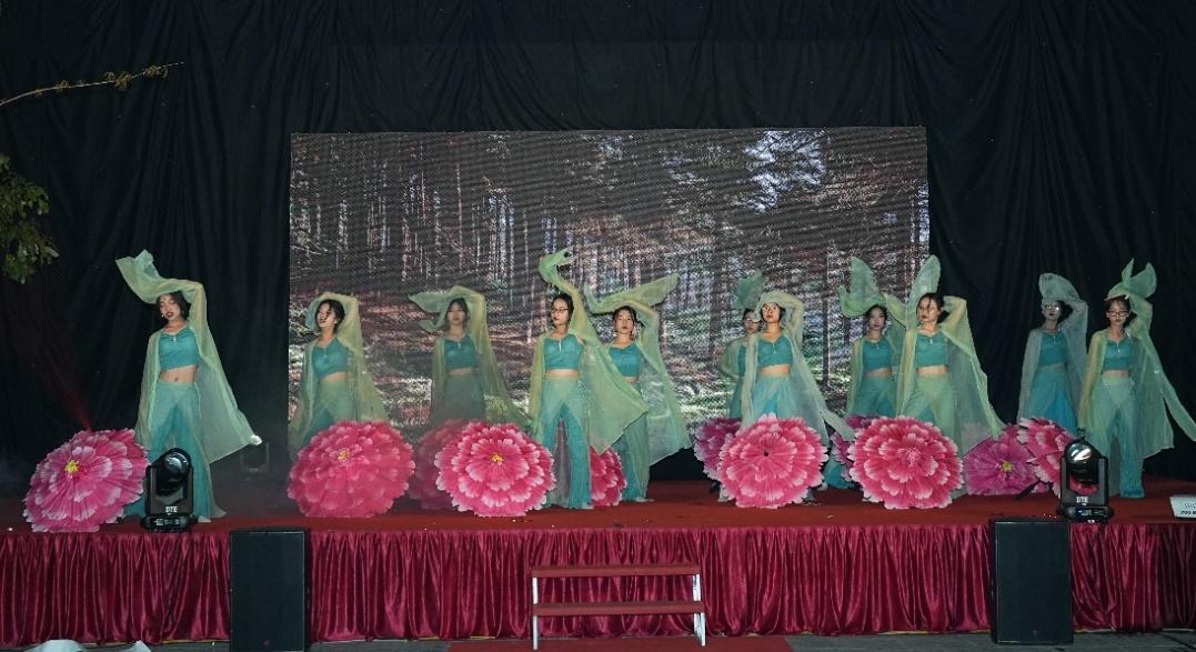 A group of women in blue dresses performing on a stage</p>
<p>Description automatically generated with low confidence