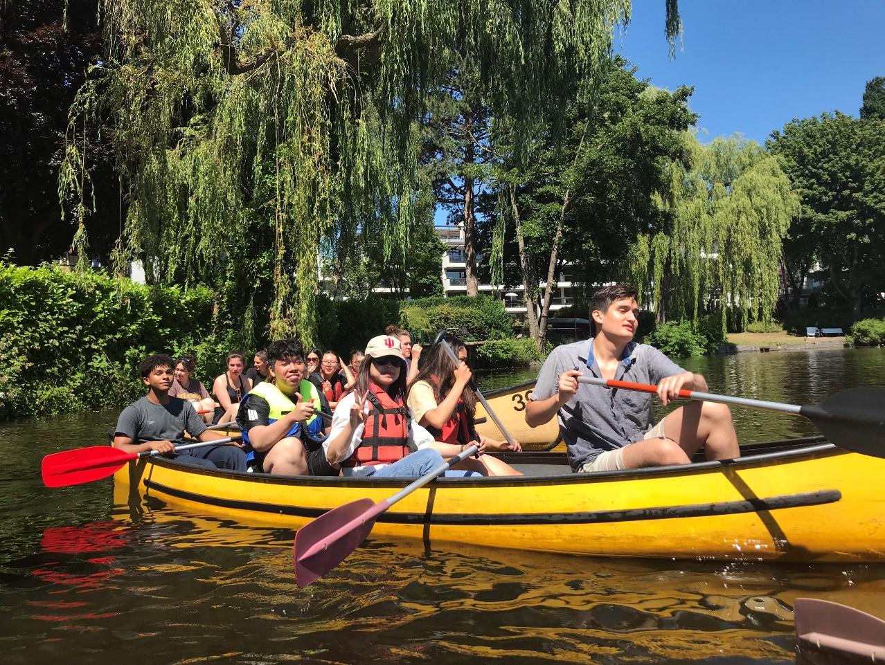 A group of people in a canoe</p>
<p>Description automatically generated with medium confidence